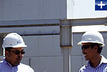 Rolls-Royce service representative with a customer at an RB211 power plant in Indonesia